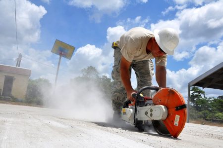 worker using a concrete hand saw