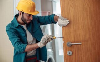 locksmith workman in uniform installing door knob 2023 01 05 00 20 11 utc