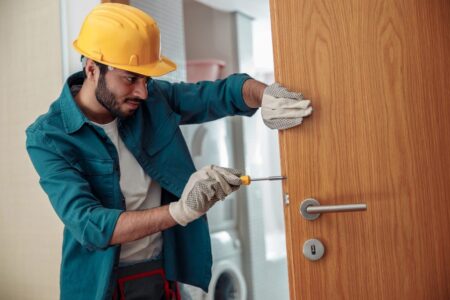 locksmith workman in uniform installing door knob 2023 01 05 00 20 11 utc
